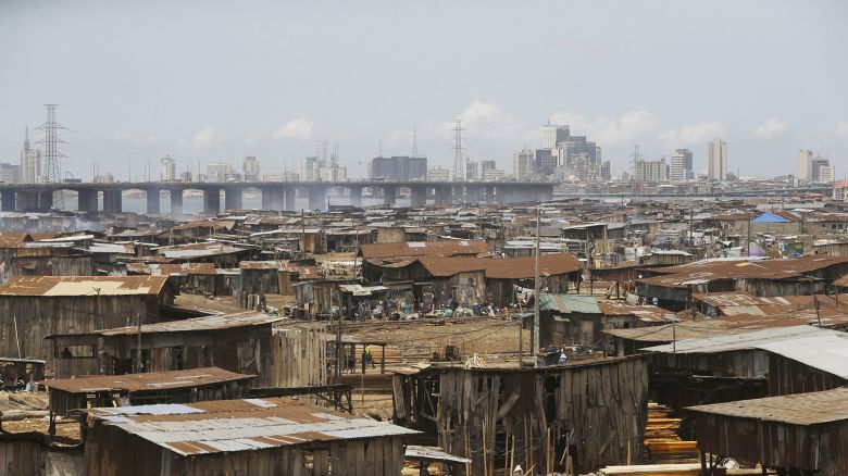 People in a slum work in a saw mill with downtown in the distance in Lagos, Nigeria, Tuesday May 12, 2020. Dim Coumou, a climate professor at Vrije Universiteit Amsterdam, said the combination of growth in African cities and climate change presents a serious risk. “As the population increases in these megacities, you have more buildings, more concrete and an increased heat-island effect, making the heat waves worse,” Coumou says. “I think it’s a dangerous combination.”