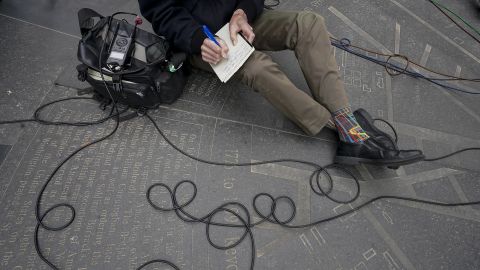 WCBS Newsradio 880 reporter Peter Haskell takes notes during a news conference in New York on March 24, 2021.