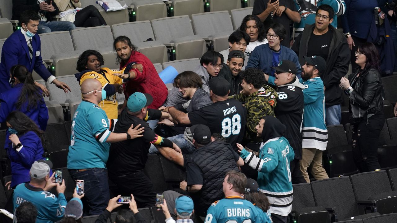 Fans fight during an NHL hockey game between the San Jose Sharks and the Nashville Predators in San Jose, Calif., Saturday, March 5, 2022. (AP Photo/Jeff Chiu)