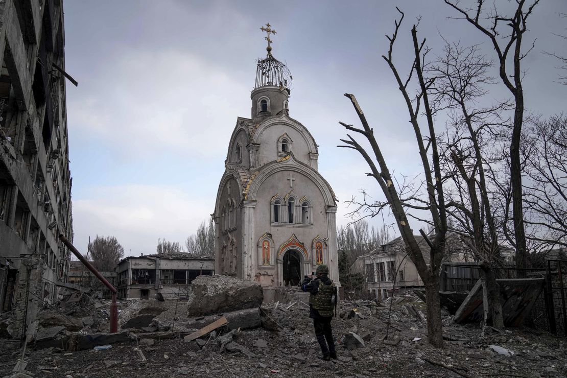 A Ukrainian serviceman takes a photograph of a church damaged in shelling in Mariupol, Ukraine, on March 10, 2022. Russian forces seized Mariupol two months later, after a brutal siege.