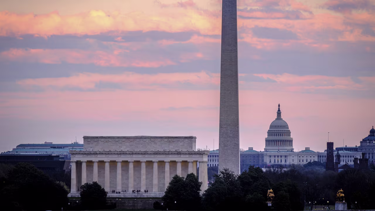 The Lincoln Memorial, the Washington Monument, and the U.S. Capitol building are seen at sunset in Washington in March 2022.