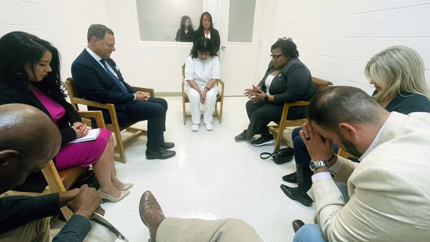 Texas death row inmate Melissa Lucio, dressed in white, leads seven Texas lawmakers in prayer in April 2022 at the Mountain View Unit in Gatesville.