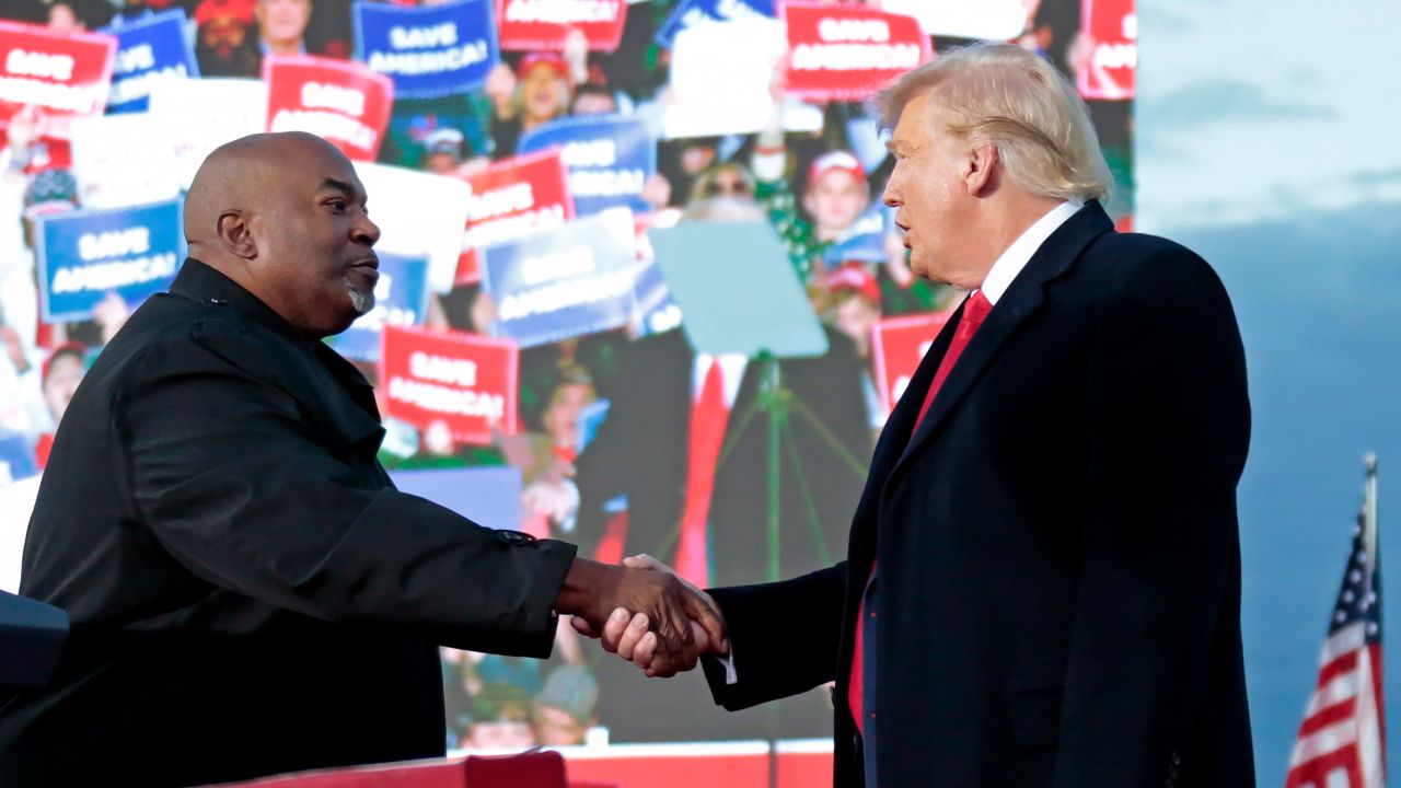 Lt. Governor Mark Robinson, left, shakes hands with former President Donald Trump during a rally in Selma, North Carolina on April 9, 2022,.