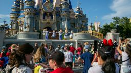 Performers dressed as Mickey Mouse, Minnie Mouse, Goofy, Donald Duck and Daisy Duck entertain visitors at Cinderella Castle at Walt Disney World Resort in Lake Buena Vista, Florida, on Monday, April 18, 2022.