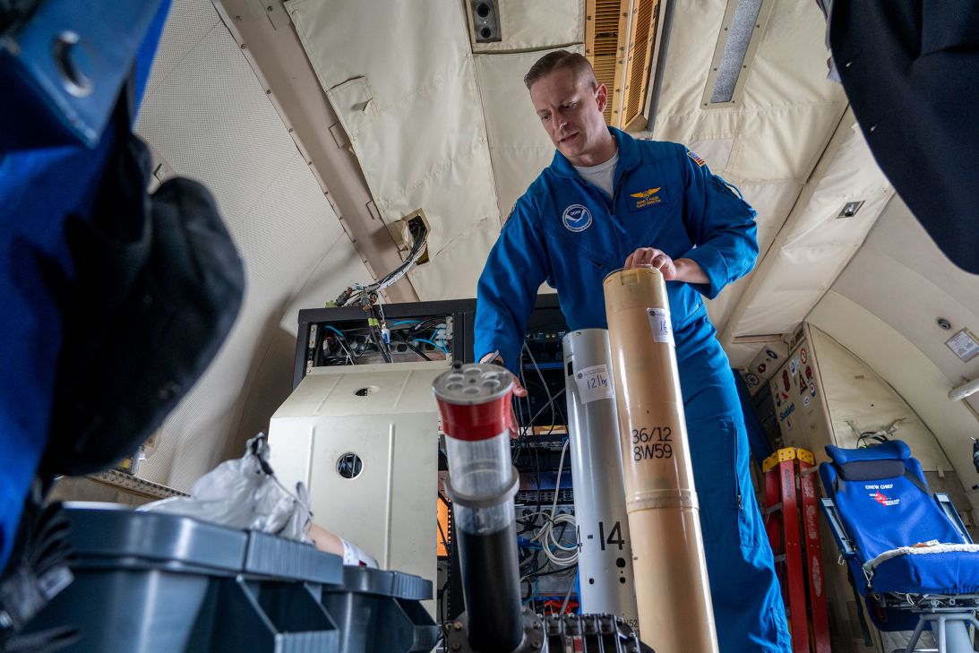 Quinn Kalen, Flight Director of NOAA's Gulfstream IV aircraft, explains the functions of WP-3D dropsondes during a hurricane awareness tour at Washington National Airport, in Arlington, Virginia, in 2022.