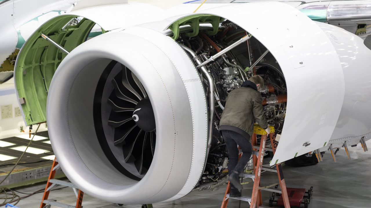 A Boeing employee works on the engine of a 737 MAX on the final assembly line at Boeing's Renton plant, June 15, 2022 in Renton, Wash.