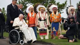 Pope Francis prays in front of Indigenous chiefs at the Ermineskin Cree Nation Cemetery in Maskwacis, Albera, during his papal visit across Canada on Monday, July 25, 2022.