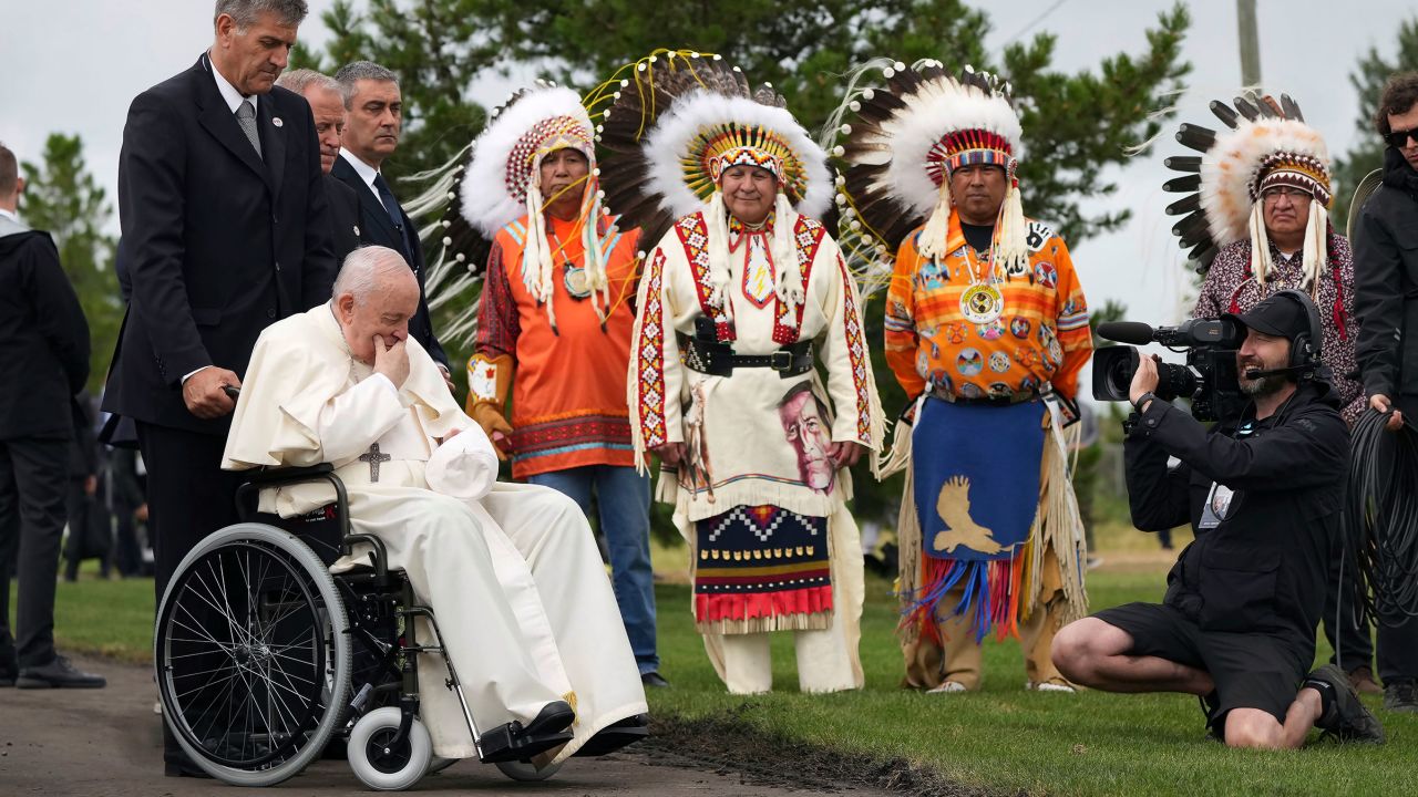 Pope Francis prays in front of Indigenous chiefs at the Ermineskin Cree Nation Cemetery in Maskwacis, Albera, during his papal visit across Canada on Monday, July 25, 2022.