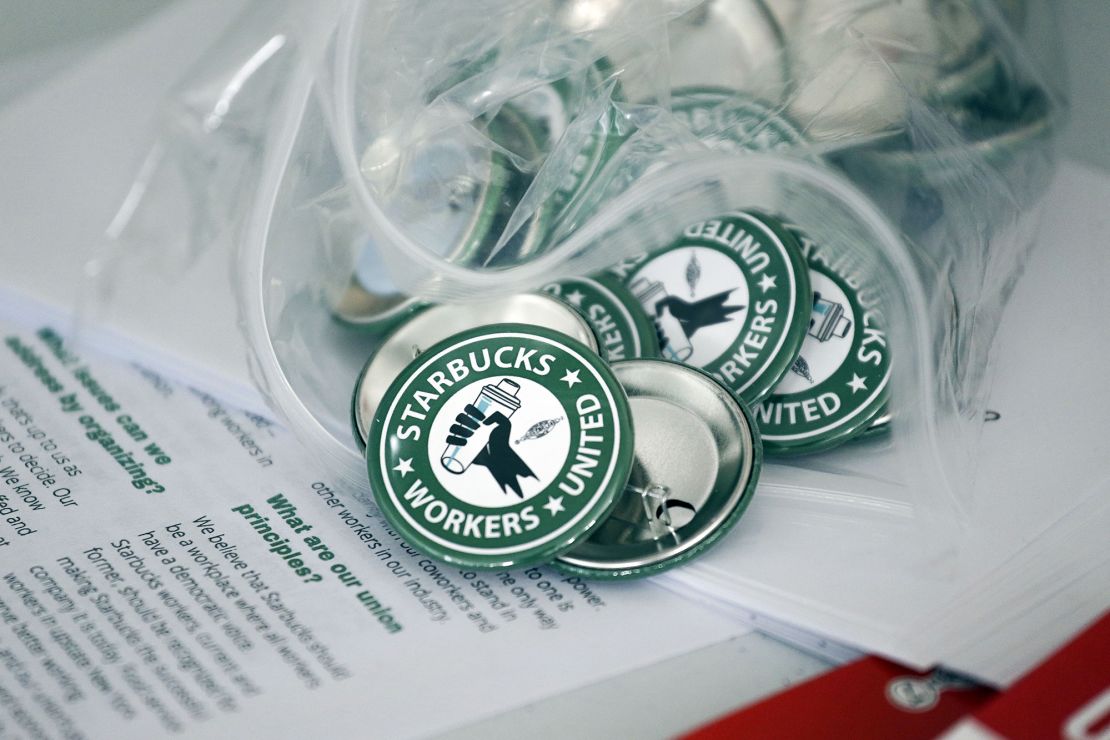 Pro-union pins sit on a table during a watch party for Starbucks' employees union election, Dec. 9, 2021, in Buffalo, N.Y.