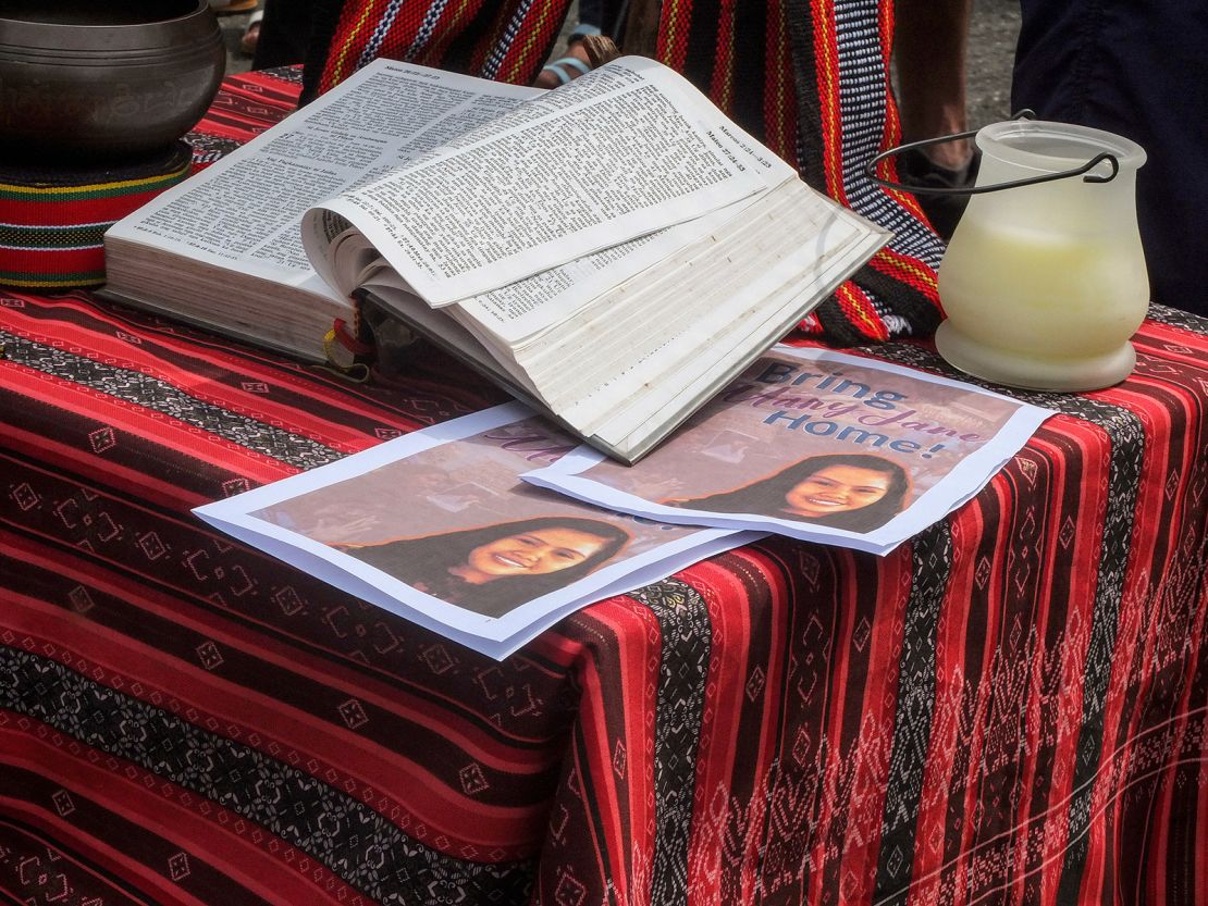 A Bible is seen next to posters of Mary Jane Veloso at a makeshift altar outside the Department of Foreign Affairs office in Pasay, Philippines, on September 6, 2022.