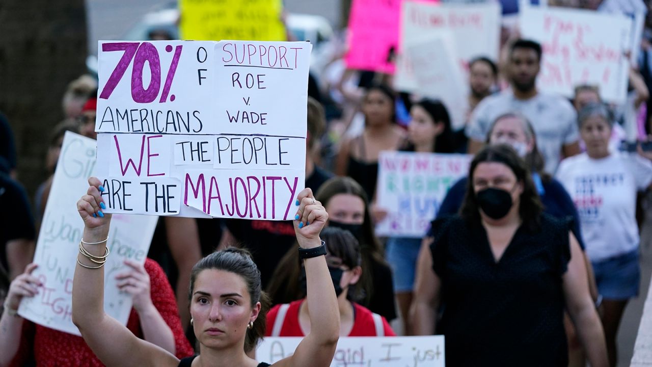 Protesters march around the Arizona State Capitol in Phoenix on June 24, 2022.