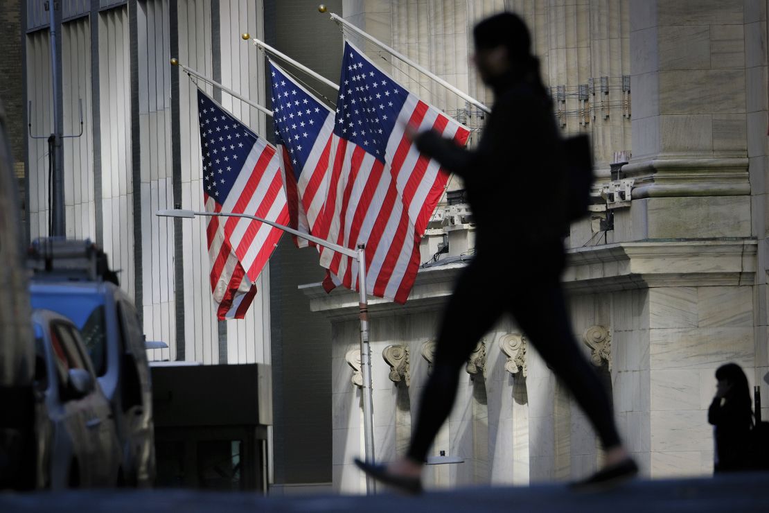 A pedestrian walks past the New York Stock Exchange on October 27, 2022.