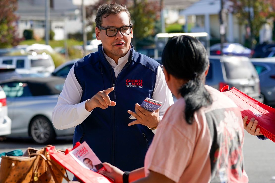 In this November 2022 photo, then-Republican candidate for New York's 3rd congressional district George Santos, talks to a voter while campaigning outside a Stop and Shop store in Glen Cove, New York.