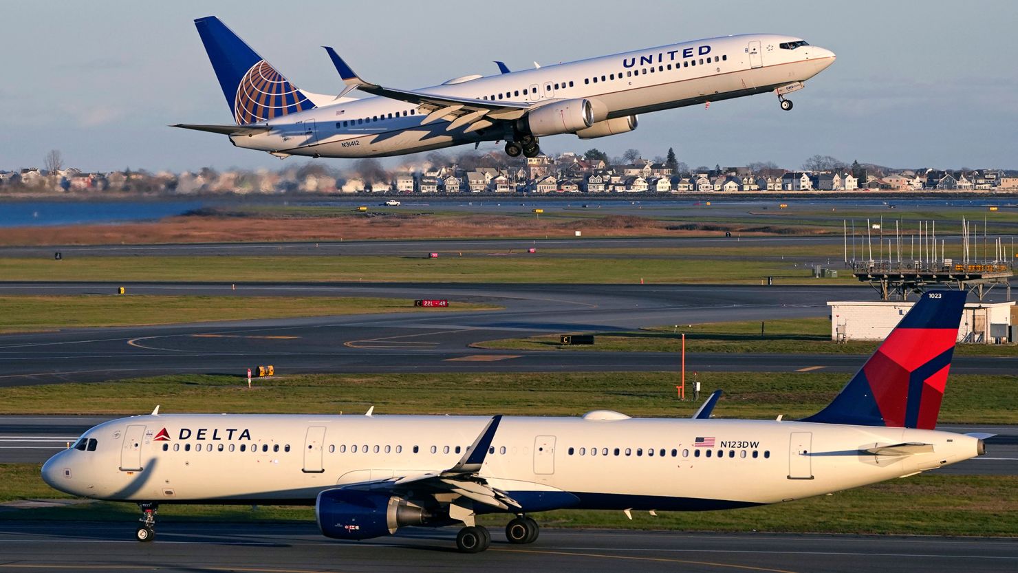 A United Airlines jet takes off while a Delta Air Lines plane taxis at Logan International Airport in Boston.