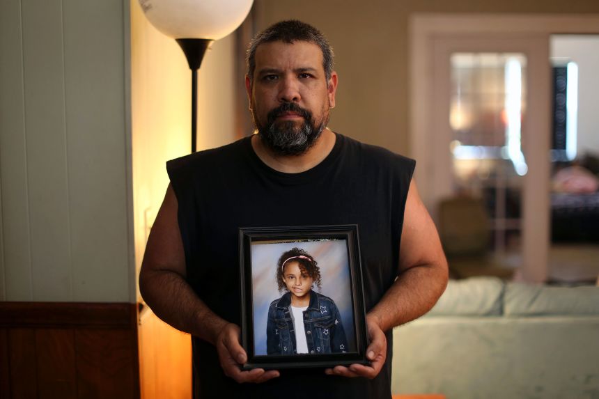 Vincent Salazar III holds a framed photograph of his daughter, Layla Salazar, at his home in Uvalde on May 26, 2022.