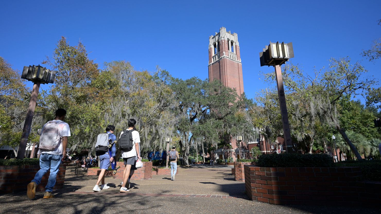 Students walk through the University of Florida campus on the last day of regular classes.
