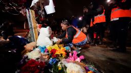 Sierra Rogers, who called Tyre Nichols her best friend, adjusts items in a memorial, after a prayer gathering at the site where he was beaten by Memphis police officers, and later died from his injuries, in Memphis, Tenn., Monday, Jan. 30, 2023. (AP Photo/Gerald Herbert)