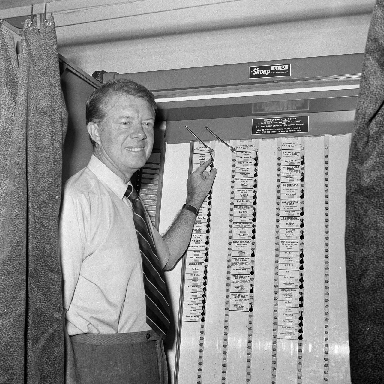 Jimmy Carter, the Georgia Democratic gubernatorial candidate, points to his name in a voting machine as he casts his vote in Plains, Georgia, on September 9, 1970.