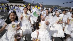 Children dressed as angels march during the Easter parade in Seoul, South Korea, on April 9, 2023.