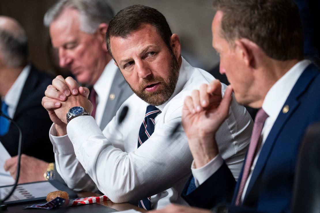 Sens. Markwayne Mullin, R-Okla., center, talks with his GOP colleagues at a Senate Armed Services Committee hearing on Wednesday, April 26, 2023.