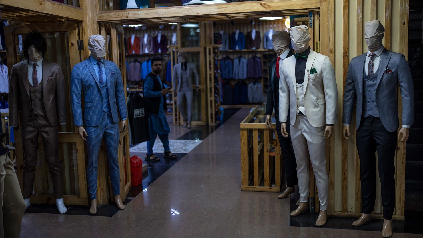 A vendor waits for customers in a clothing store downtown in Kabul, Afghanistan, Friday, May 26, 2023. The Government of the Taliban prohibited the faces of the mannequins that are in commercial stores from being seen.
