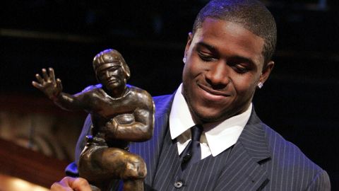 FILE - Southern California tailback Reggie Bush picks up the Heisman Trophy after being announced as the winner of the award Saturday, Dec. 10, 2005, in New York. Former Southern California running back Reggie Bush plans to file a defamation lawsuit against the NCAA over a statement made by college sports' governing body about the reasoning for its decision not to restore the Heisman Trophy winner's records. Bush announced his plan Wednesday, Aug. 23, 2023, through his attorneys at McCathern PLLC.(AP Photo/Julie Jacobson, File)