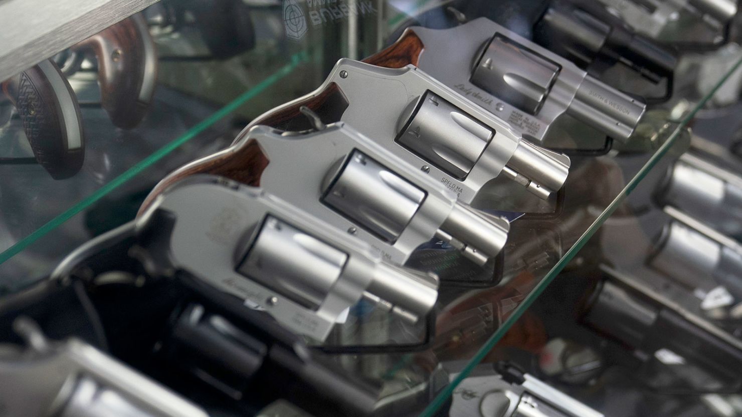 A sales associate arranges a display of guns at a firearms store in Burbank, California.