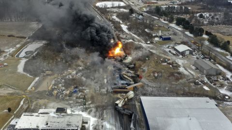 This photo taken with a drone shows portions of a Norfolk Southern freight train that derailed Friday night in East Palestine, Ohio, are still on fire at mid-day Saturday, Feb. 4, 2023. The rail company announced it has reached a $600 million settlement with residents affected by the derailment.