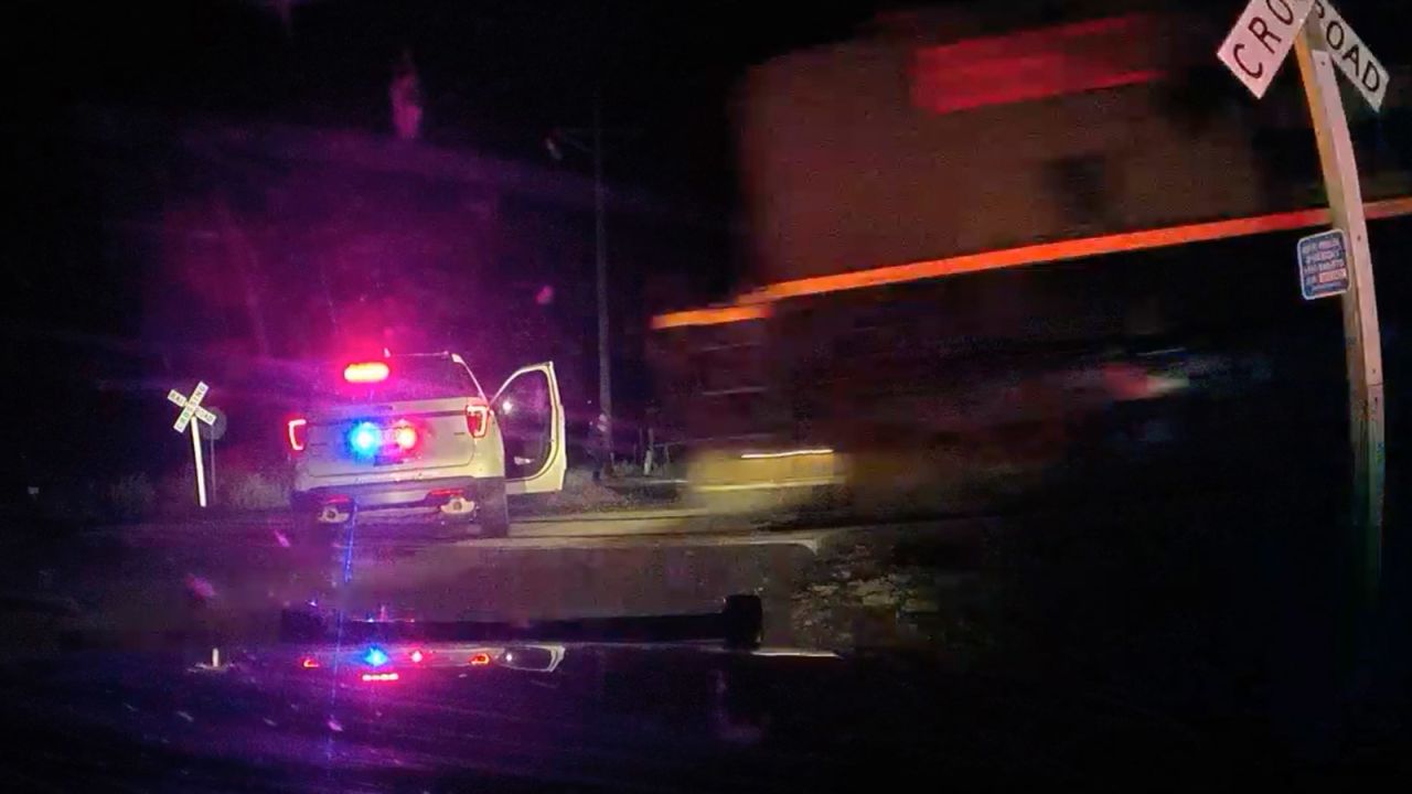 Dash camera video provided by the Fort Lupton Police Department shows a freight train barreling toward a parked police car with a suspect insideon  September 16, 2022.