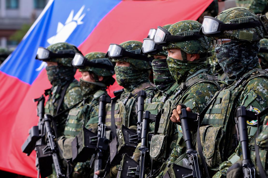 Soldiers pose for group photos with a Taiwan flag after a preparedness enhancement drill simulating the defense against Beijing's military intrusions in Kaohsiung City, Taiwan on January 11, 2023.