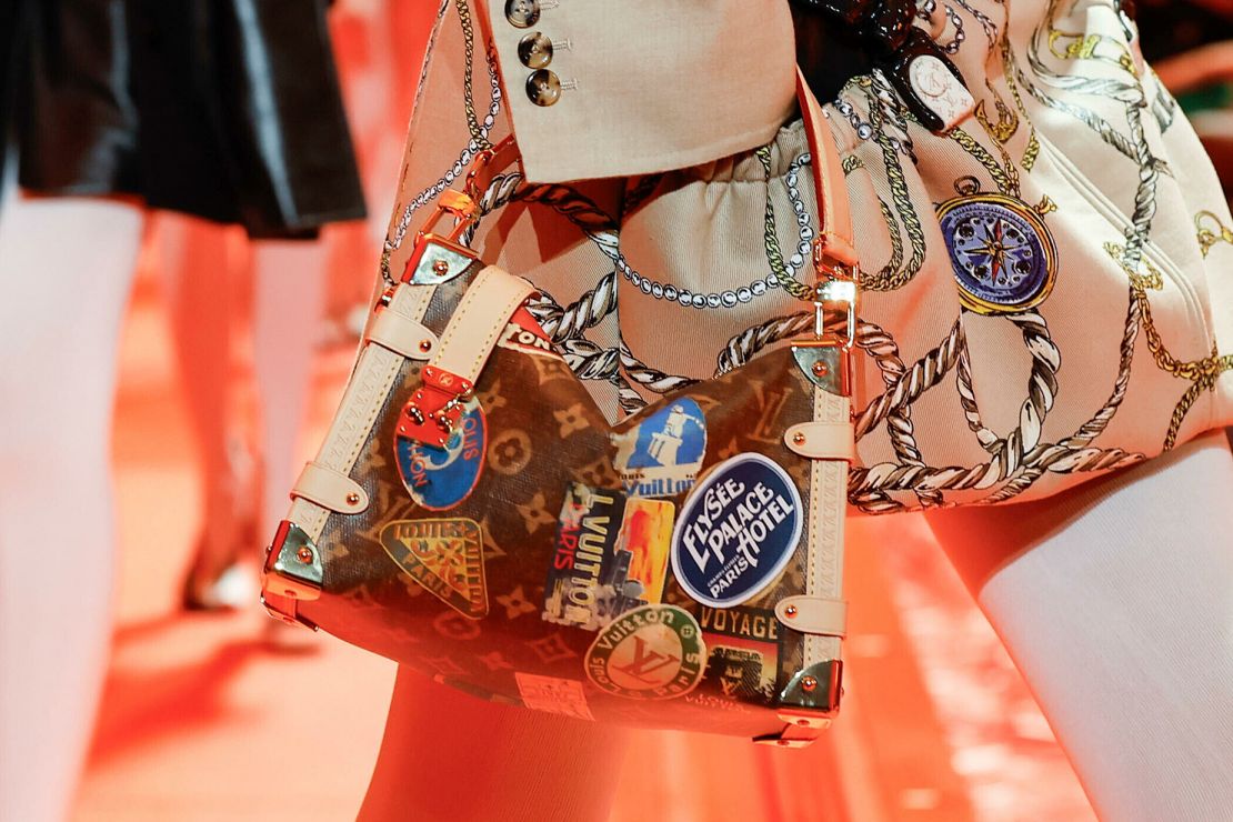 The latest Louis Vuitton collection looked to the power of travel, a theme perhaps most visible in this season's accessories — one bag was made in the shape the Arc de Triomphe, while others mimicked vintage luggage stickers.