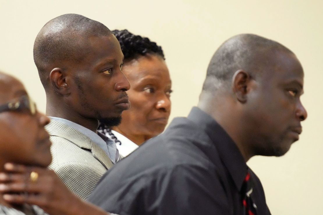 Michael Corey Jenkins, center, and Eddie Terrell Parker, right, listen as one of six former Mississippi law officers pleads guilty to state charges at the Rankin County Circuit Court in Brandon, Mississippi, August 14, 2023.
