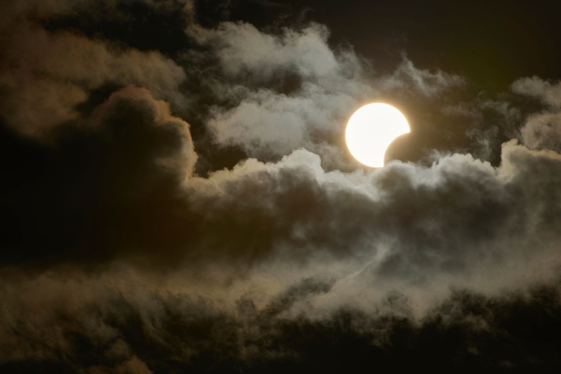 A partial solar eclipse is seen between clouds from Socorro in Sao Paulo, Brazil on October 14, 2023.