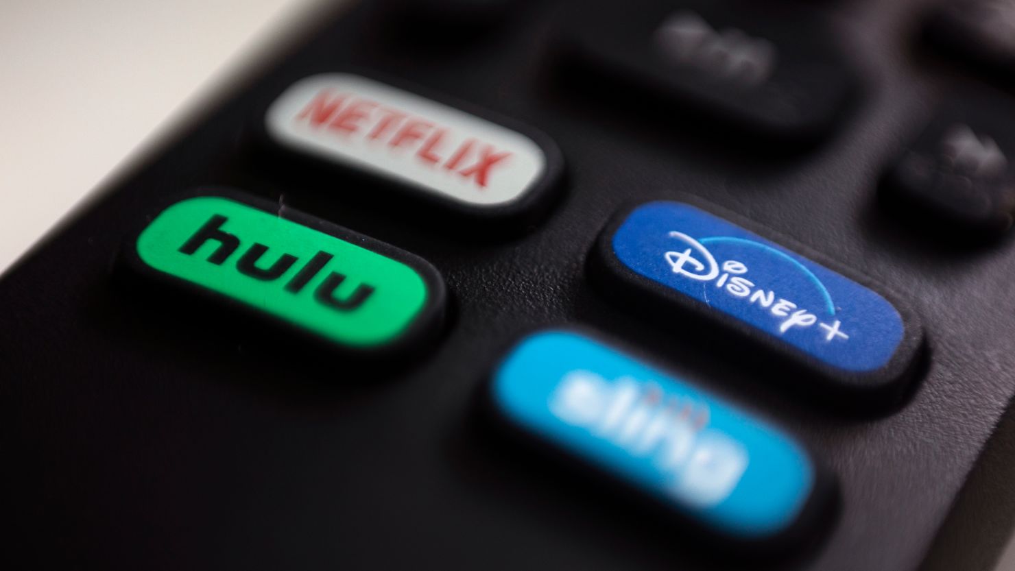 The logos of Hulu and Disney Plus are pictured on a remote control in Portland, Oregon on August 13, 2020.