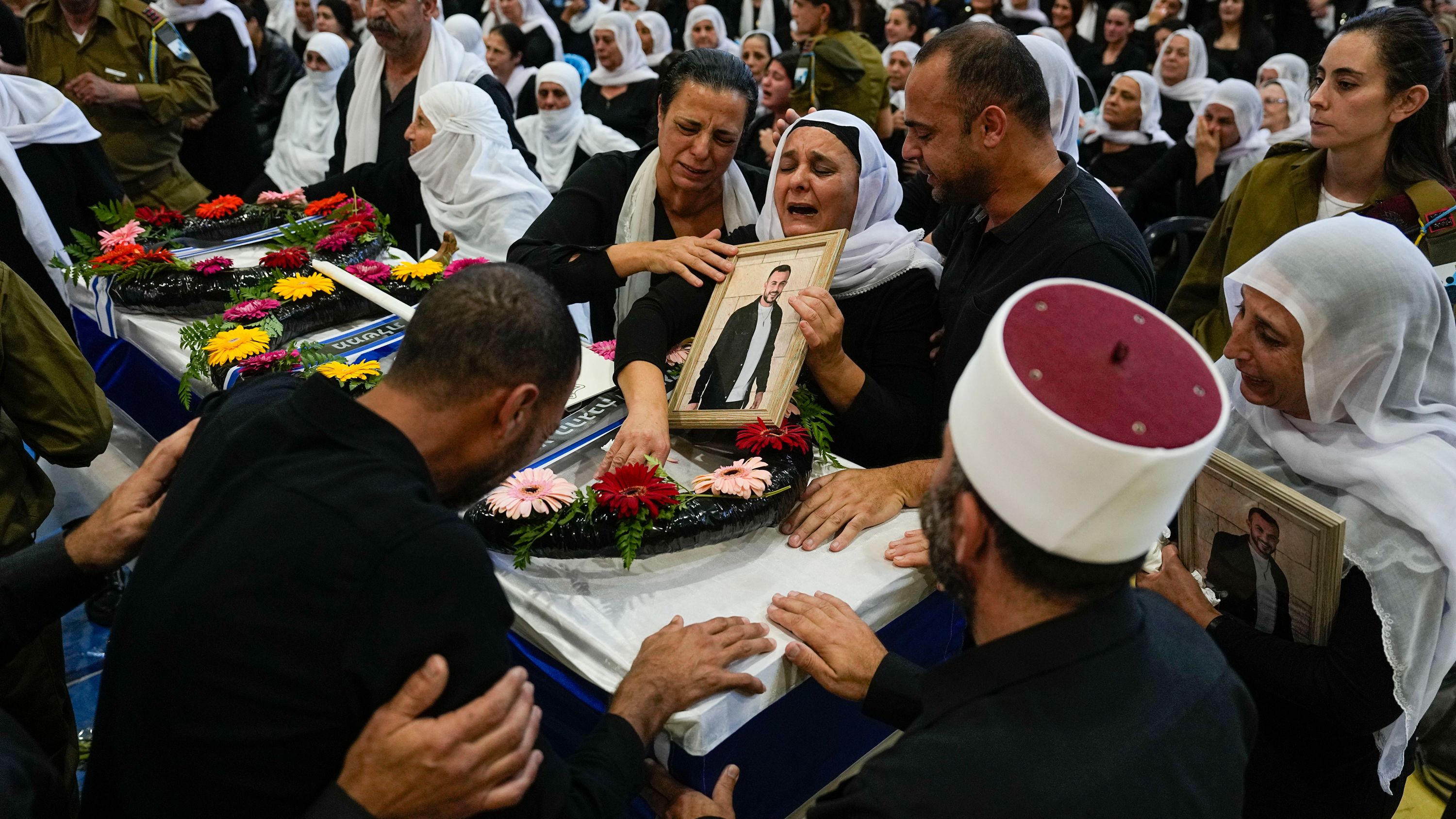 Mourners gather around the coffin of Druze Israeli Lt. Col. Salman Habaka in the village of Yanuh Jat, northern Israel, on November 3. Habaka was killed during a ground operation in the Gaza Strip.