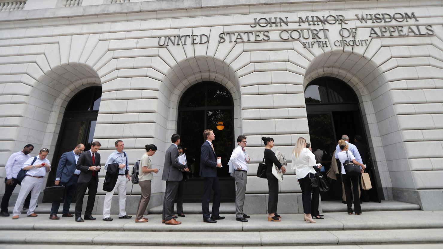 FILE - People wait in line to enter the 5th Circuit Court of Appeals in New Orleans, Jan. 9, 2019. Members of a three-judge panel at the 5th U.S. Circuit Court of Appeals in New Orleans on Tuesday, Nov. 7, 2023, heard an appeal by the Biden administration to a lower court ruling in Texas last year that blocked the use of the government's abortion guidance. (AP Photo/Gerald Herbert, File)