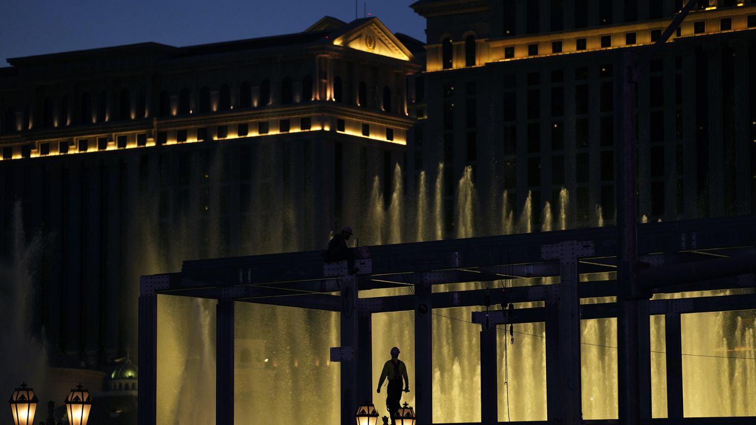 A construction worker helps build a grandstand in front of the fountains at Bellagio hotel-casino along the Las Vegas Strip ahead of the Las Vegas Formula One Grand Prix auto race Tuesday, Sept. 19, 2023, in Las Vegas.