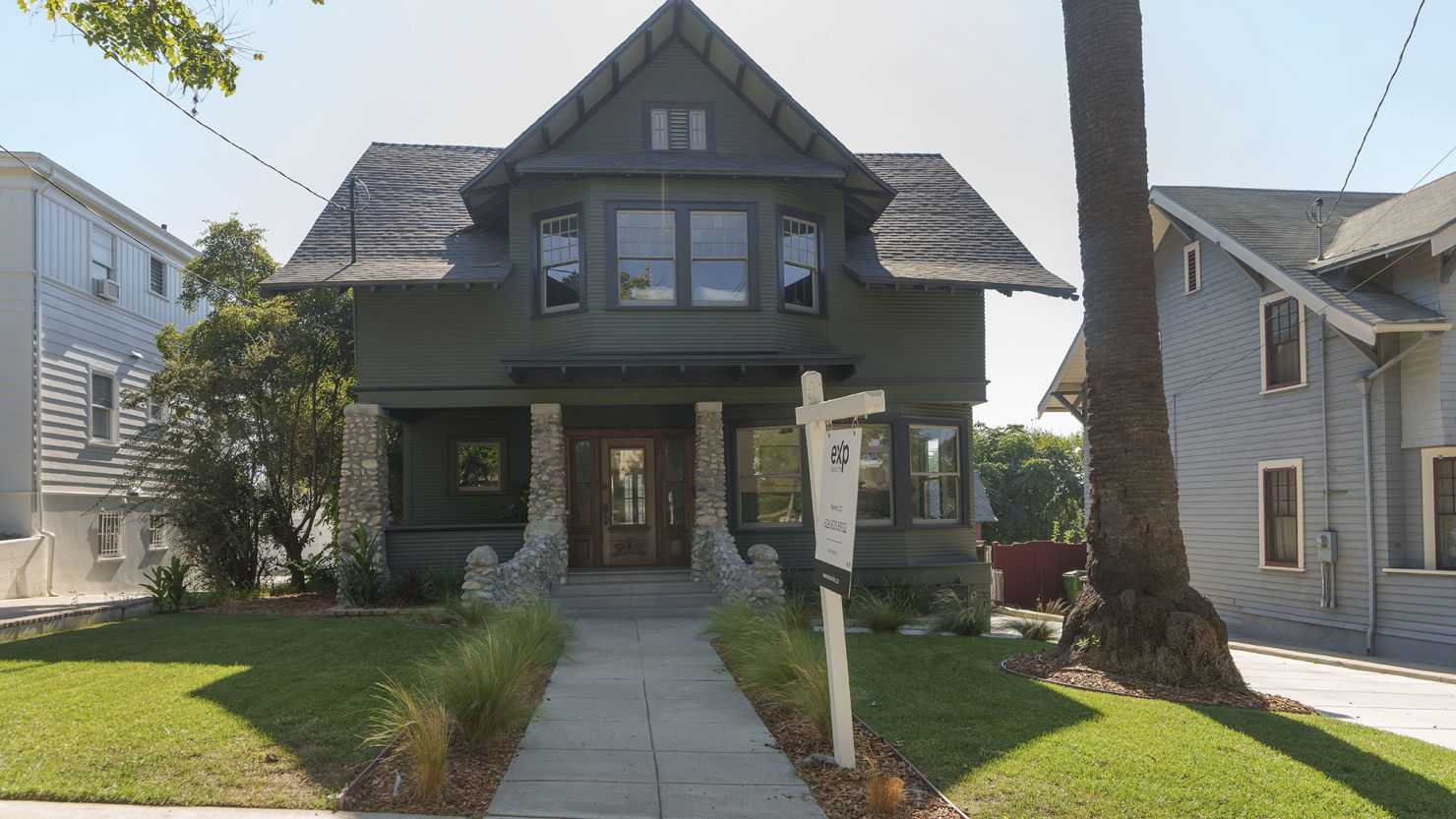 A for sale sign is posted outside a home in the Angelino Heights historical neighborhood of Los Angeles, on Oct. 19, 2023.