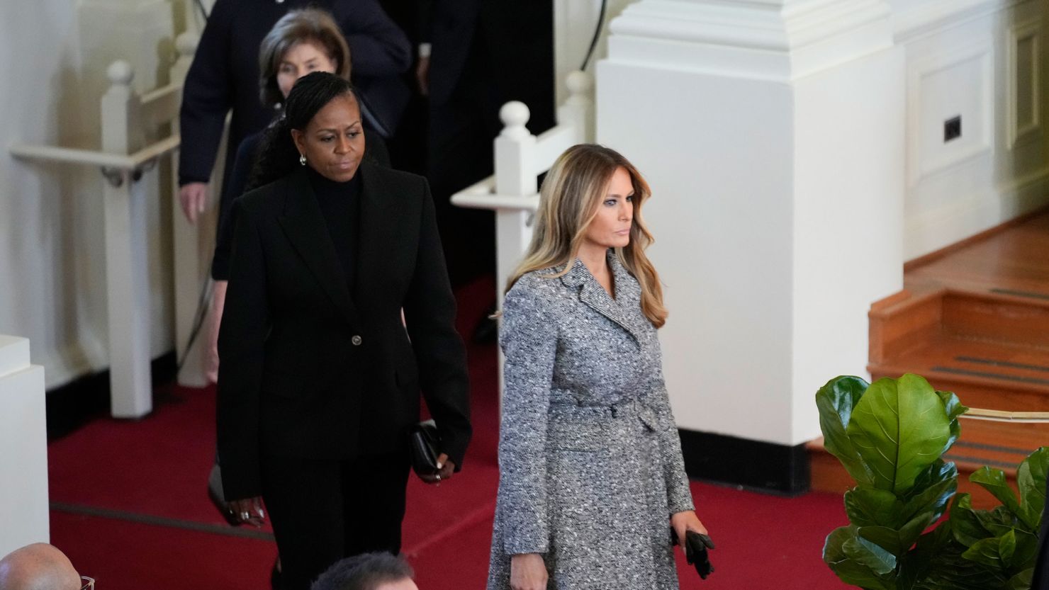 Former first ladies, from right, Melania Trump, Michelle Obama, Laura Bush and Hillary Clinton, arrive to attend a tribute service for former first lady Rosalynn Carter at Glenn Memorial Church on Tuesday, November 28, in Atlanta.