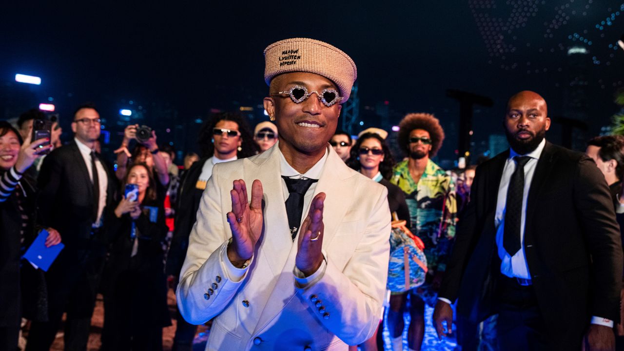 Designer Pharrell Williams applauds at the conclusion of the Louis Vuitton Men's Pre-Fall 2024 Fashion Show, presented in Hong Kong, Thursday, Nov. 30, 2023. (AP Photo/Louise Delmotte)