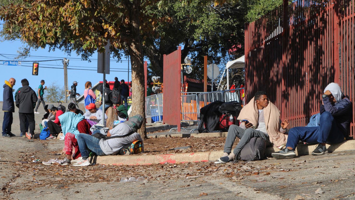 People wait outside the Migrant Resource Center in San Antonio in 2023.