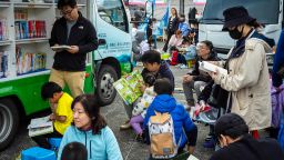 Children read books at mobile library during the Reading Festival in Taipei, Taiwan on December 3, 2023.