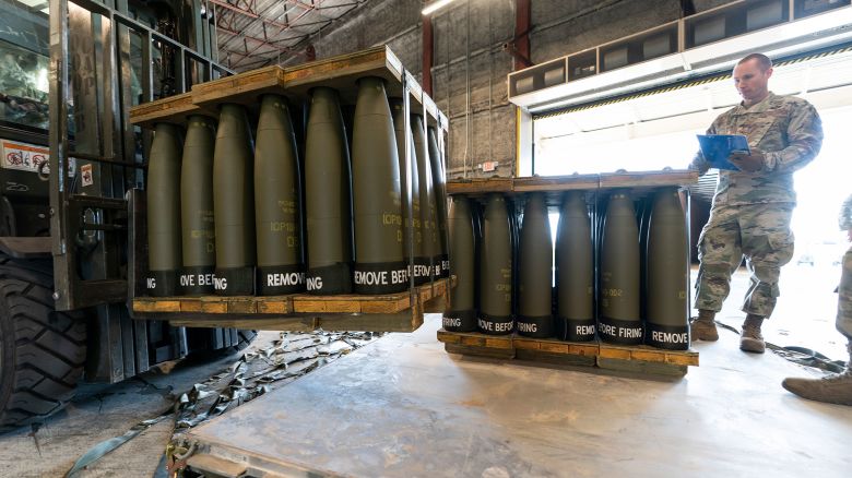 In this April 2022 photo, US Air Force Staff Sgt. Cody Brown, right, with the 436th Aerial Port Squadron, checks pallets of 155 mm shells ultimately bound for Ukraine at Dover Air Force Base in Delaware.