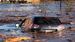 A car floats in a flooded parking lot at the Hathaway Creative Center in Waterville, Maine, after a severe storm flooded rivers.