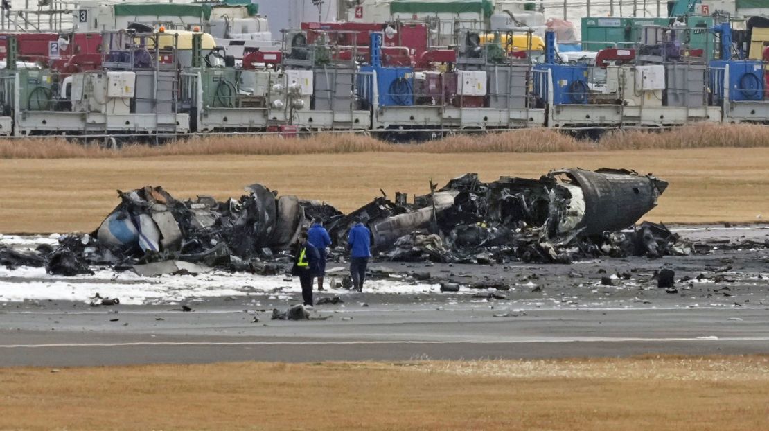 The burn-out Japanese coast guard aircraft is seen at Haneda airport on January 3, 2024, in Tokyo, Japan.