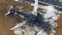 This aerial photo show the burn-out Japan Airlines plane at Haneda airport on Wednesday, Jan. 3, 2024, in Tokyo, Japan. The large passenger plane and a Japanese coast guard aircraft collided on the runway at Tokyo's Haneda Airport on Tuesday and burst into flames, killing several people aboard the coast guard plane, officials said. (Kyodo News via AP)