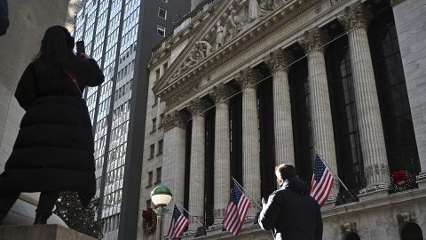 People walk past the New York Stock Exchange (NYSE) on the first trading day of 2024 on January 02, 2024 in New York City.