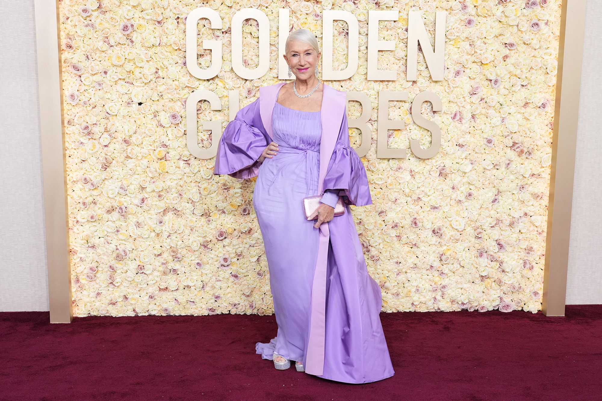 Helen Mirren looked regal in a lavender Dolce & Gabbana dress and oversized puff-sleeved opera coat, silver platforms by Sole Bliss and Harry Winston jewelry.