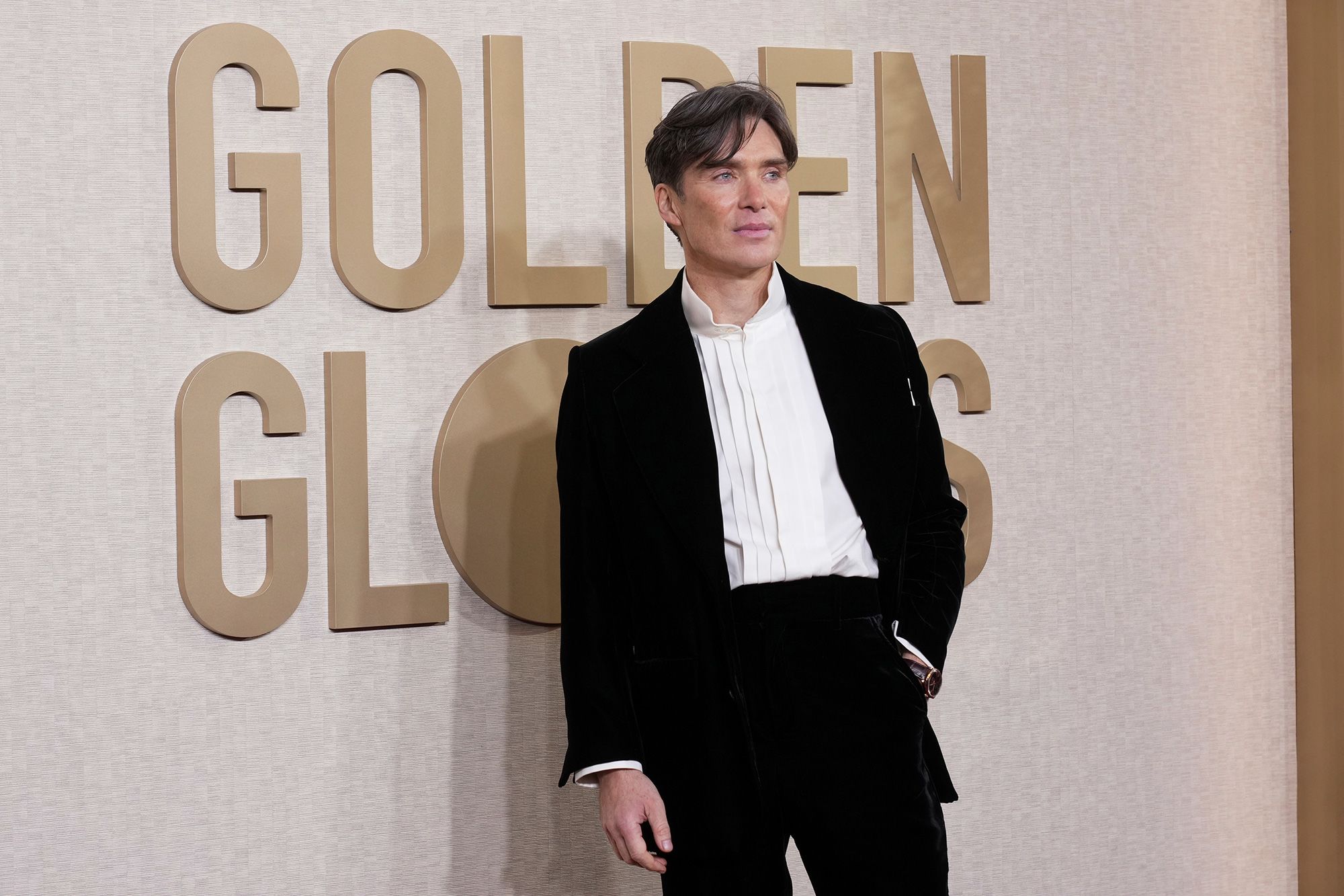 Cillian Murphy, who went on to win a Golden Globe for his performance in “Oppenheimer,” wore a classic black Saint Laurent suit with a white shirt and no tie.