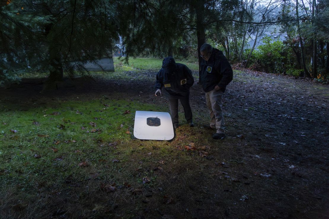 The door plug from Alaska Airlines Flight 1282 is examined where it landed in a yard after the January 5, 2024 flight.